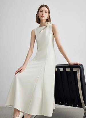Minimalist ivory A-line midi dress styled with black handbag