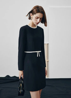 Tailored fashion dress styled with a black bag