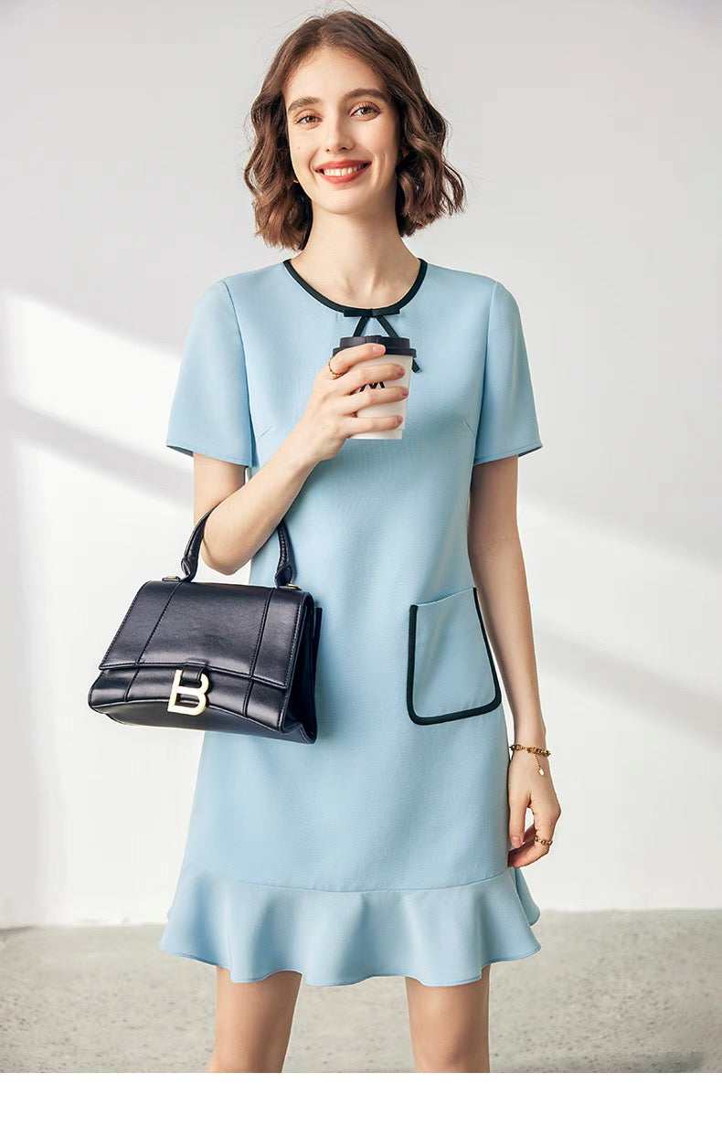 Front view of petite woman wearing acetate tweed dress