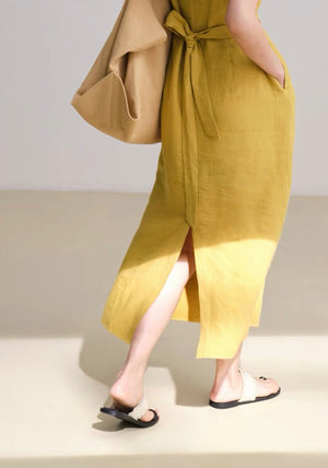 Close-up of knot detail on natural linen midi dress