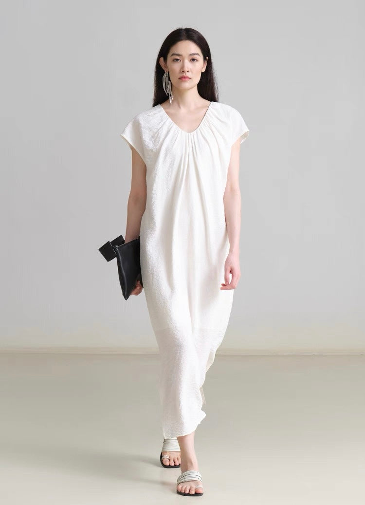 Close-up of textured linen fabric with gathered neckline detail