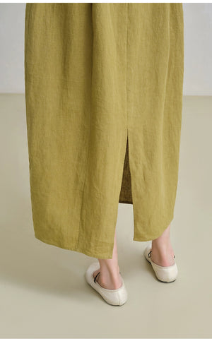 Side profile of woman wearing minimalist linen V-neck dress