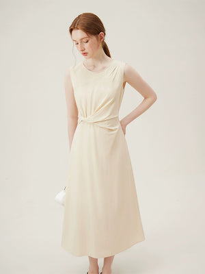 Neutral-toned cotton midi dress styled with black sandals and white handbag