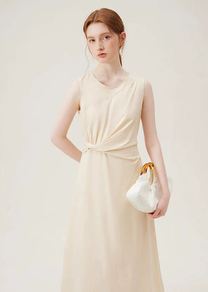 Woman wearing beige cotton jersey sleeveless midi dress with twist waist detail
