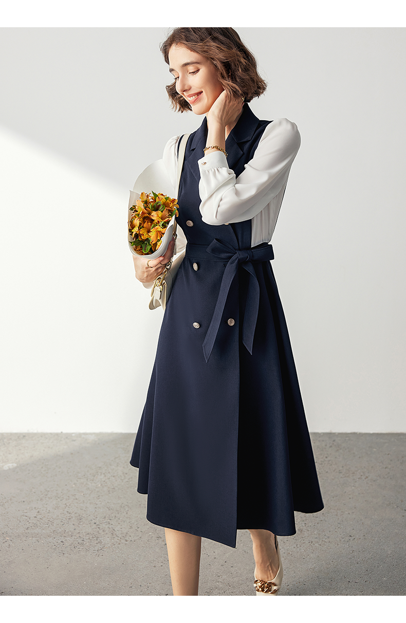 Woman holding flowers wearing tailored midi business dress