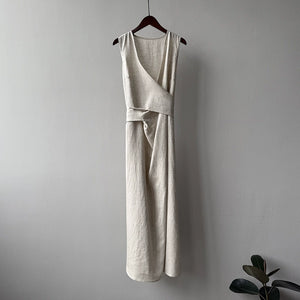 Slimming linen maxi dress styled with woven bag