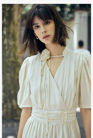 Close-up of V-neck maxi dress with rose tie detail