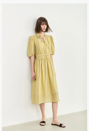 Close-up of V-neck maxi dress with rose tie detail