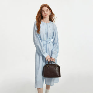 Elegant blue cotton dress styled with leather accessories