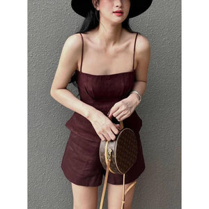Woman wearing burgundy linen co-ord set and hat
