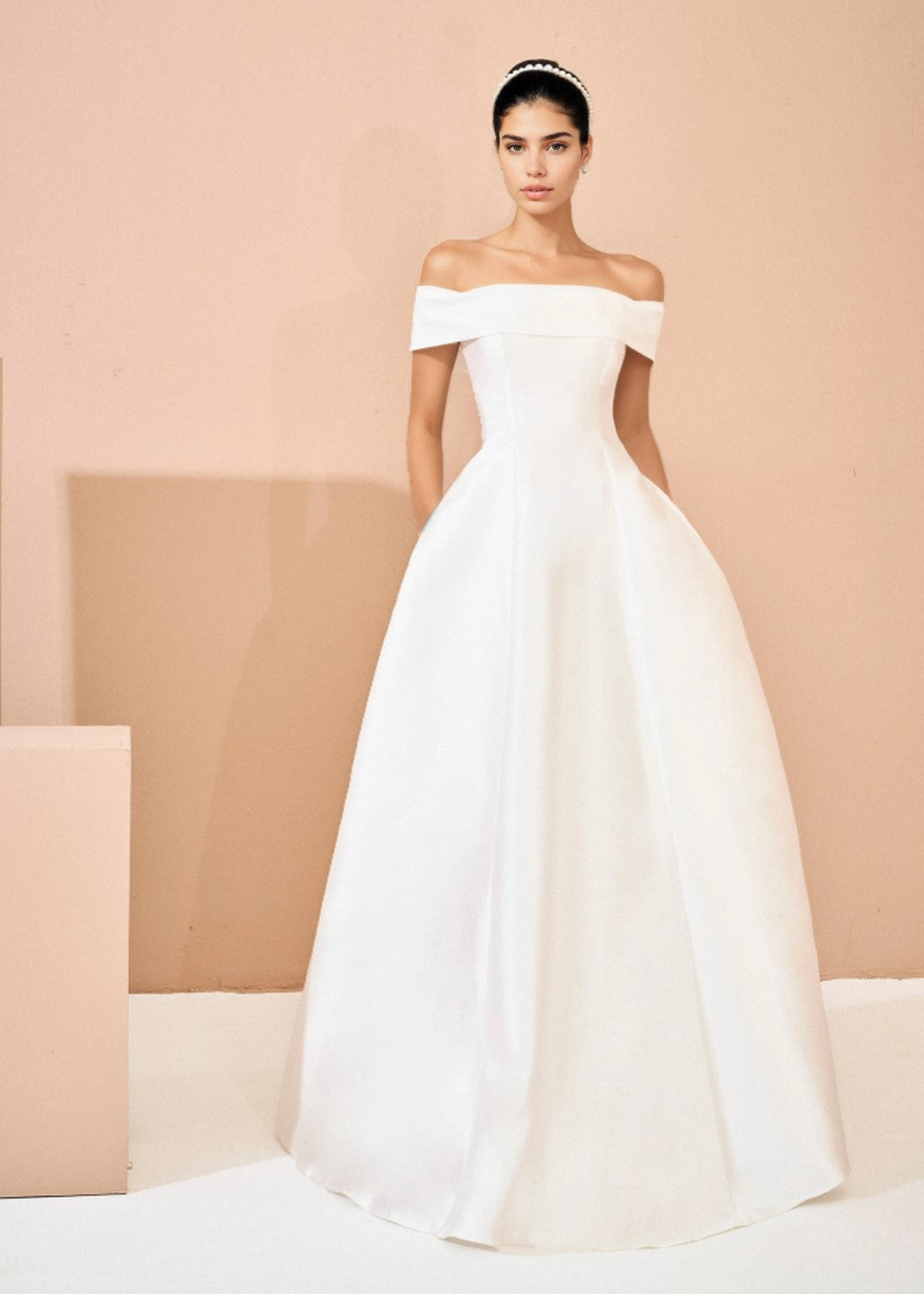 The off-shoulder princess-style wedding gown has a flared silhouette.