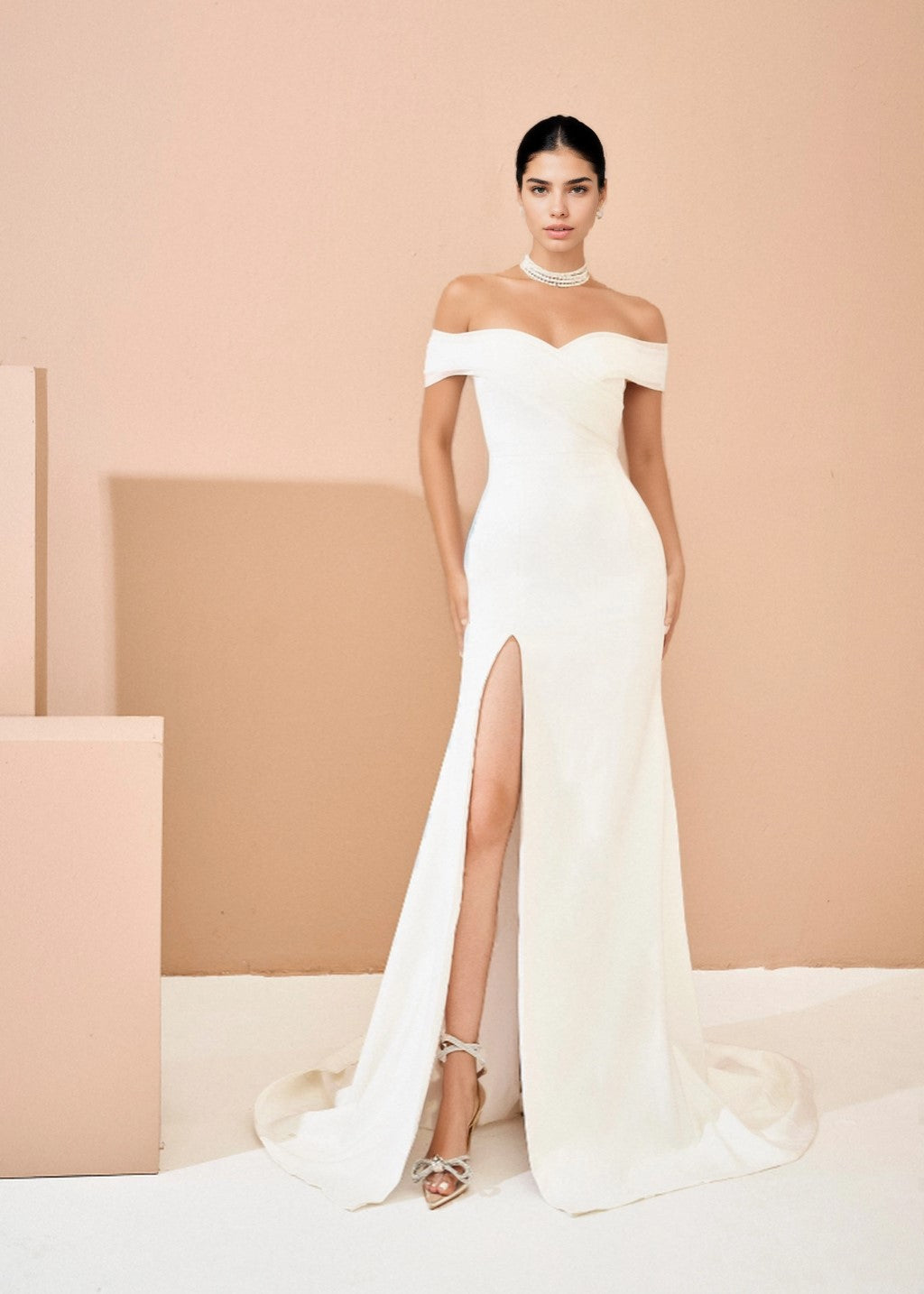 The off-shoulder fishtail wedding dress has a slit at the tail.