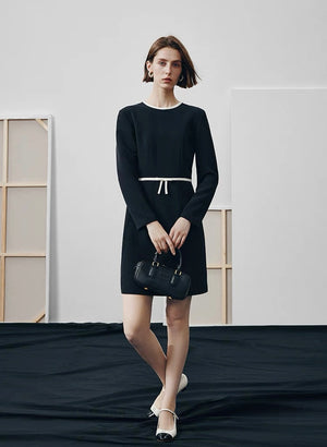 Tailored fashion dress styled with a black bag