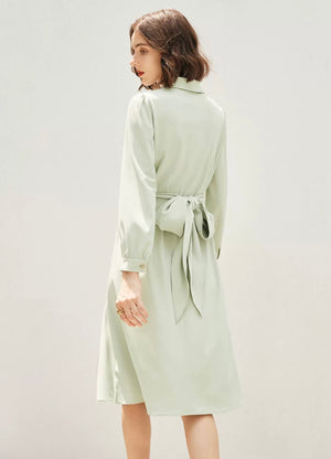 Mid-length green dress styled with a yellow bag