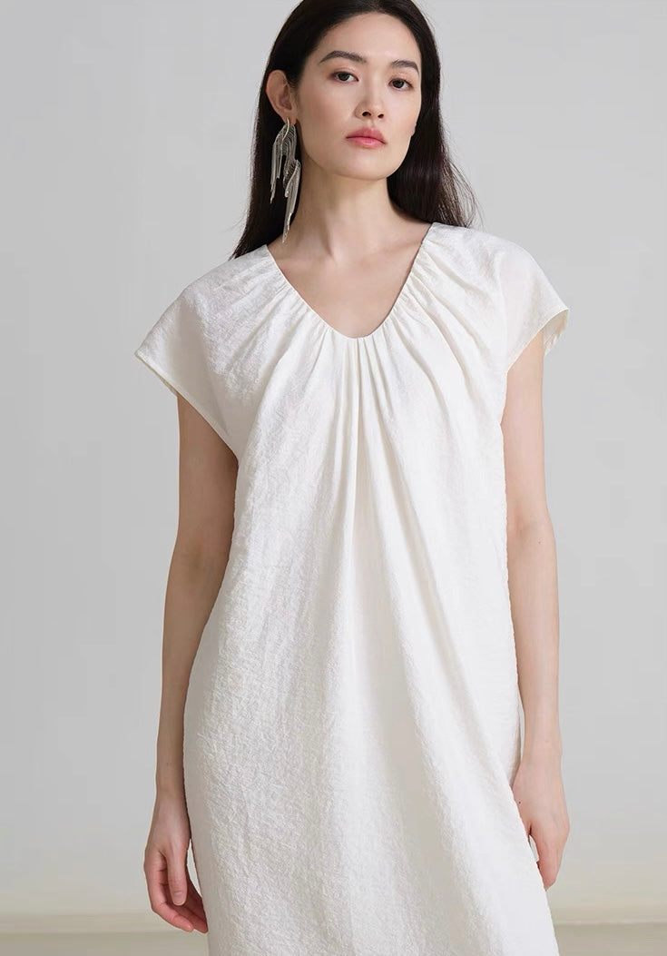 Back view of V-neck linen dress showing relaxed fit and soft drape