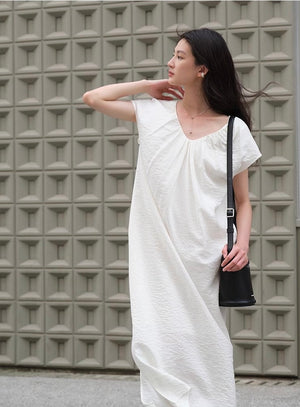 Draped minimalist linen midi dress styled with sandals