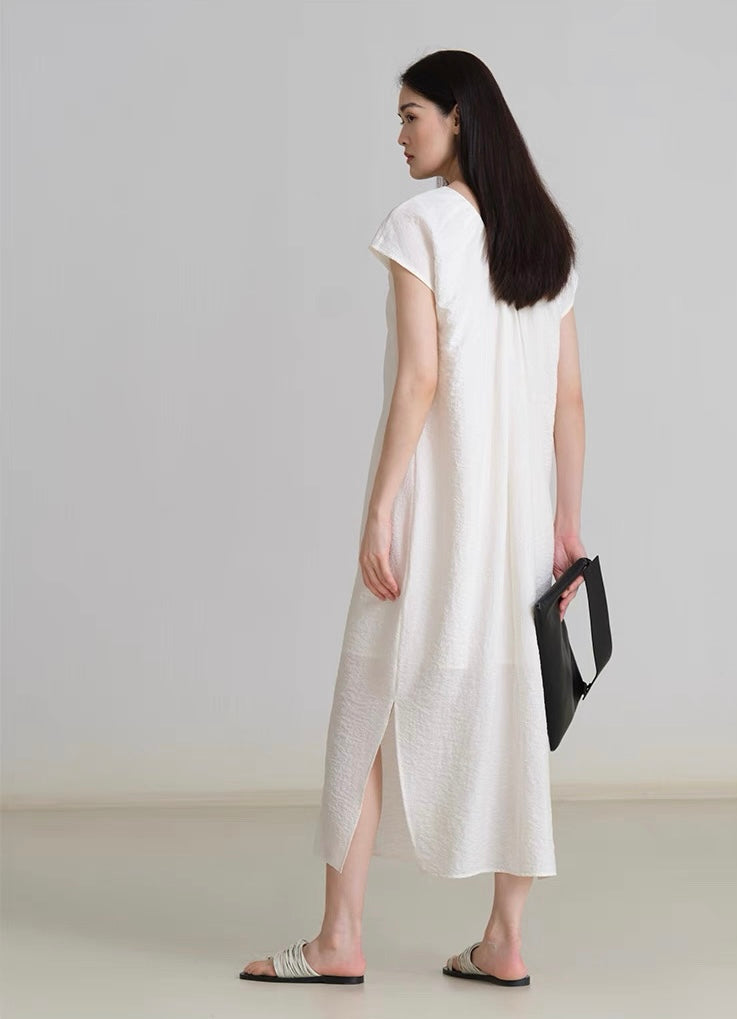 Flat lay of sleeveless V-neck linen dress on hanger