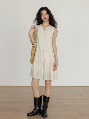 Taileroom short vest-style dress with subtle buttonsLightweight sleeveless linen dress with basket bag