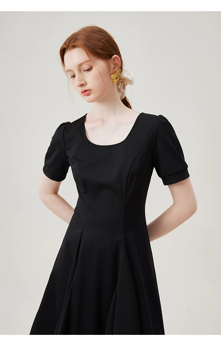 Puff sleeve hem detail on black cotton dress