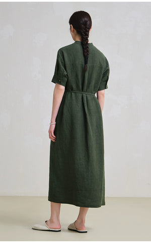 Woman wearing button-front linen midi dress with waist tie and rolled sleeves