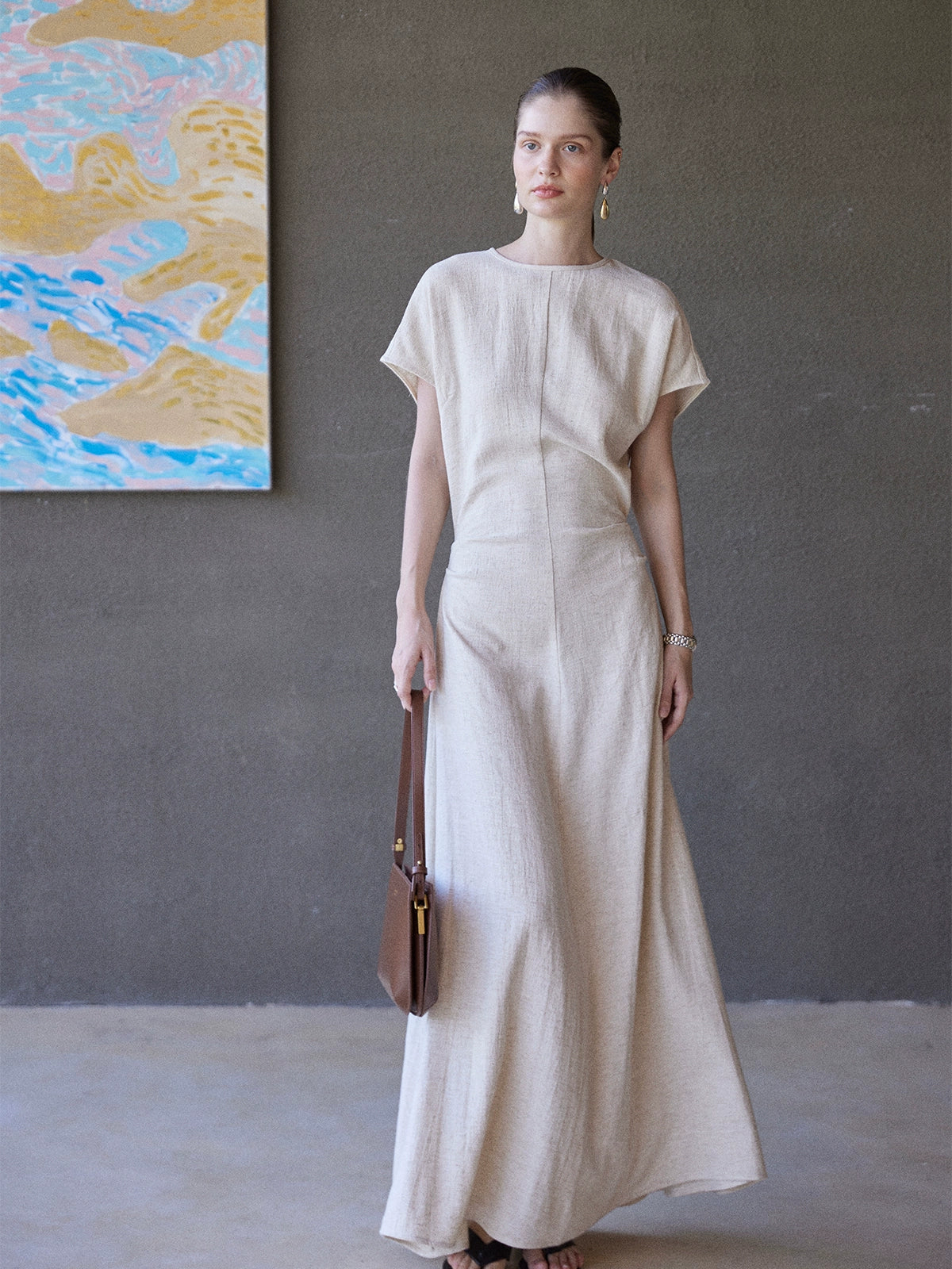 Full-length linen dress styled with brown bag
