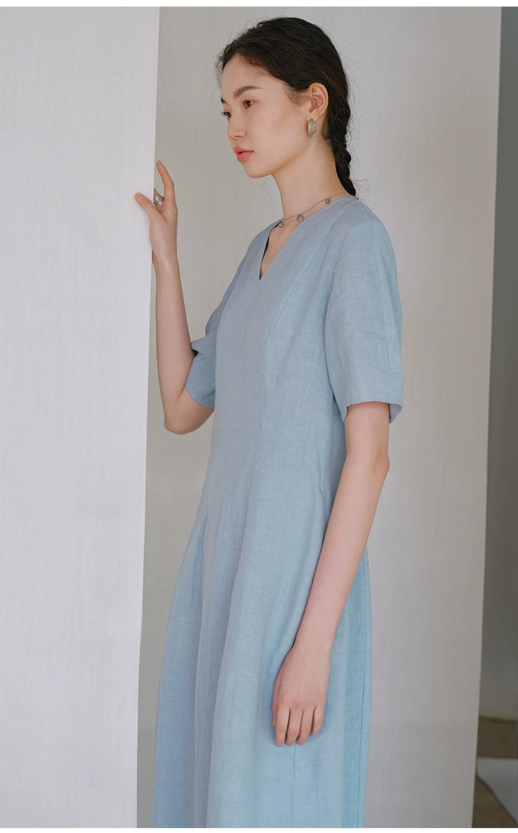 Model in linen midi dress with tailored fit and short sleeves