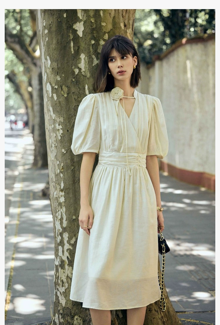 Vintage-inspired rose dress with puff sleeves and waist detail