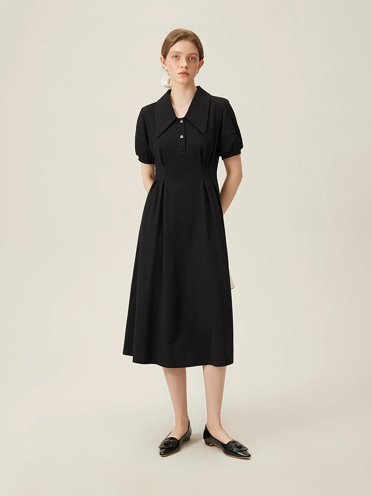 Model wearing black linen dress with puff sleeves and wide collar holding-two-tone 