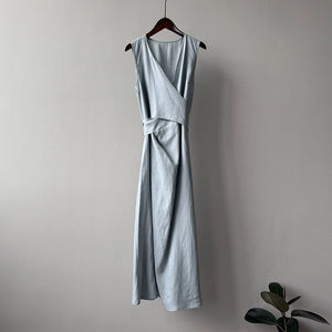 Slimming linen maxi dress styled with woven bag