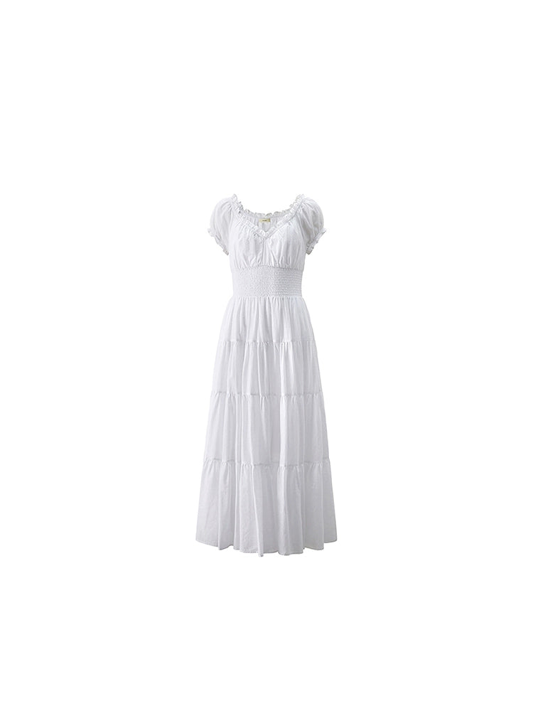 Elegant white dress with tiered skirt and puff sleeves