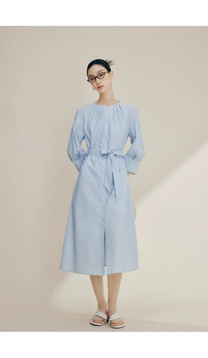 Front view of cream cotton shirt dress with brown buttons