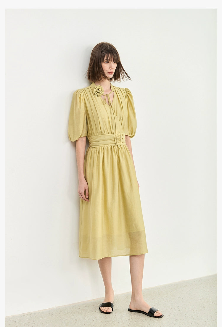 Close-up of V-neck maxi dress with rose tie detail