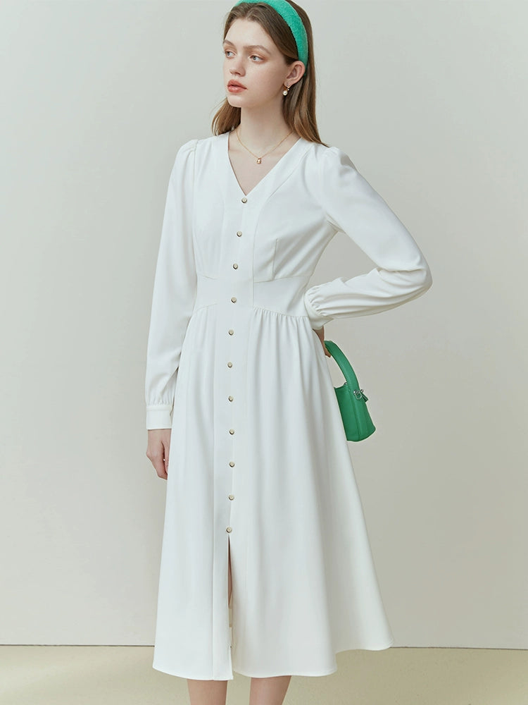 Side view of ivory linen dress highlighting fitted waist and short sleeves