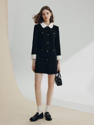 Front view of black coat dress with white collar and cuffs