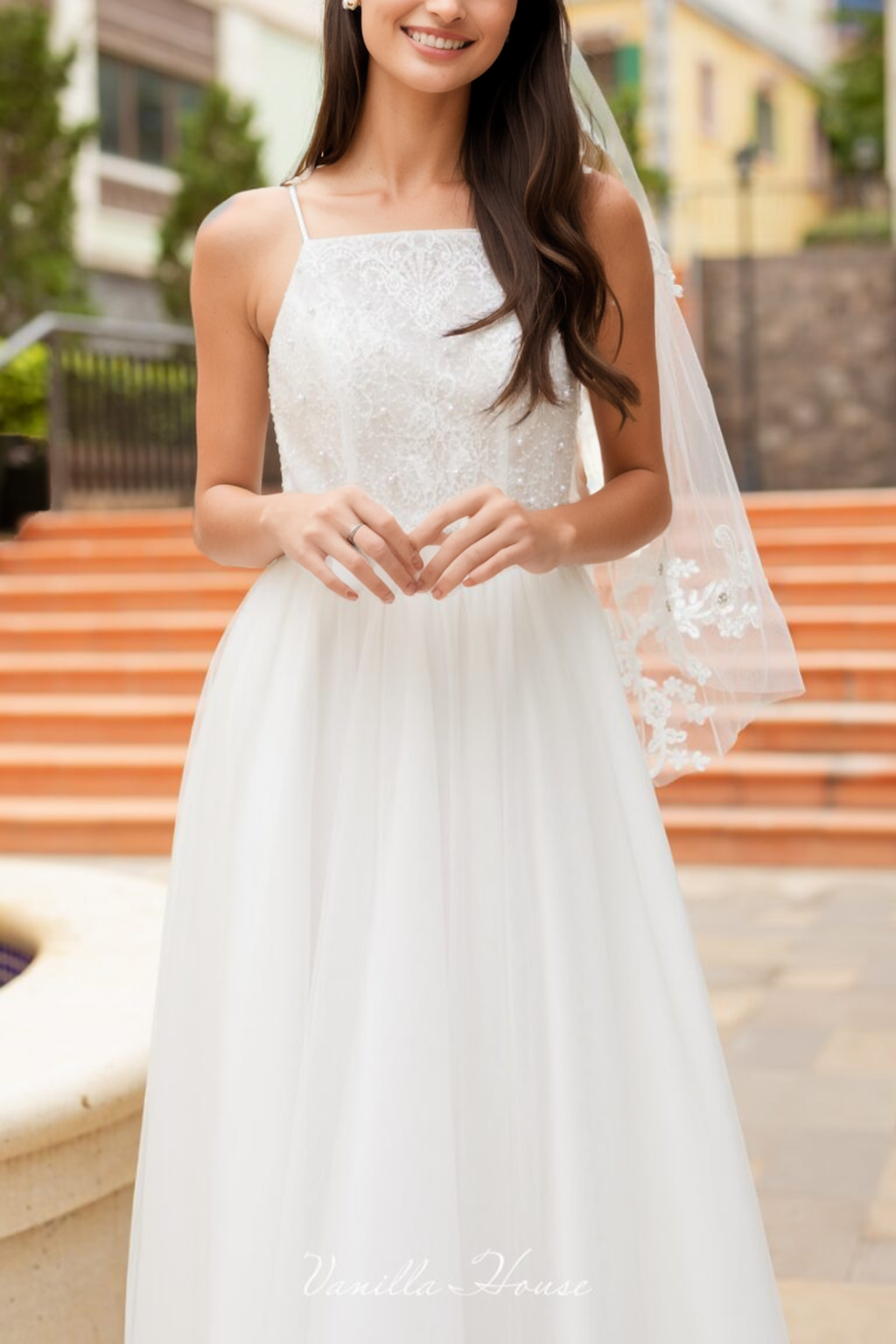 Beaded bodice dress with a mesh veil